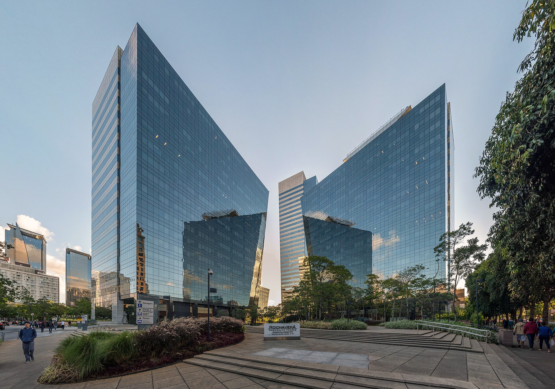 Torres corporativas de vidro ao entardecer, representando o ambiente de negócios